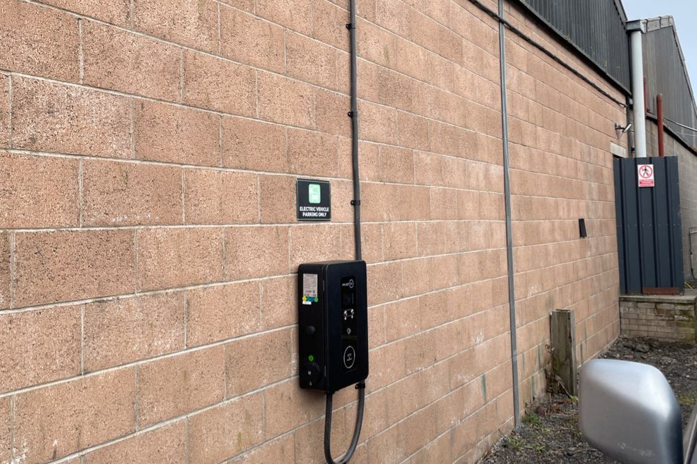 Wall-mounted EV charger on an industrial building